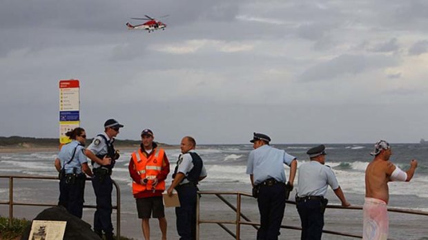 Missing boy ... police and emergency services personnel at Towradgi rock pool during last night's search.