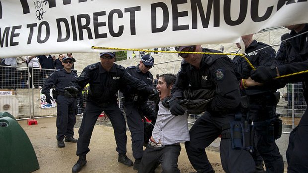 A man is dragged from City Square by police.