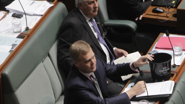 Liberal backbencher Tony Smith with a plastic pot during question time.