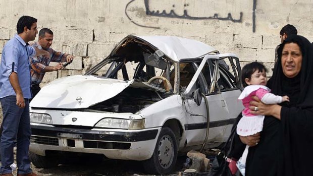 Iraqis inspect the aftermath of a car bombing in the eastern Baghdad neighbourhood of Zayona on Wednesday.
