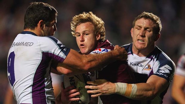 Surrounded ... Daly Cherry-Evans is monstered by the Storm defence.