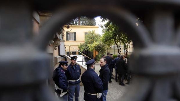 Police officers stand guard outside the Chilean embassy in Rome.