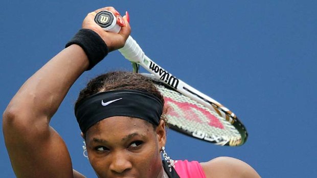 Focussed ... Serena Williams returns a shot against Ana Ivanovic.