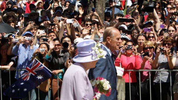 Monarchy rules ... the Queen and Prince Philip on parade in Canberra.