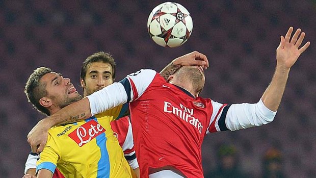 Napoli's Swiss midfielder Gokhan Inler (L) vies with Arsenal's French striker Olivier Giroud.