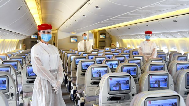 Emirates cabin crew are wearing PPE (personal protection equipment) on board flights.