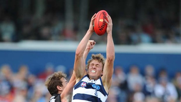 Geelong's Mitch Duncan stretches to take a mark.