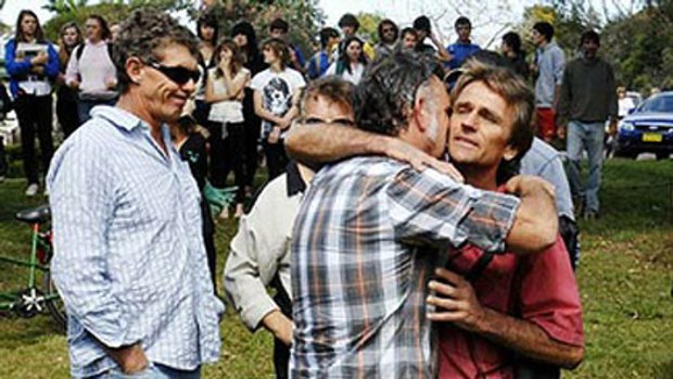 Jai Morcom's father, Steve Drummond, right, is supported by friends and relatives during yesterday's student walk-out at Mullumbimby.