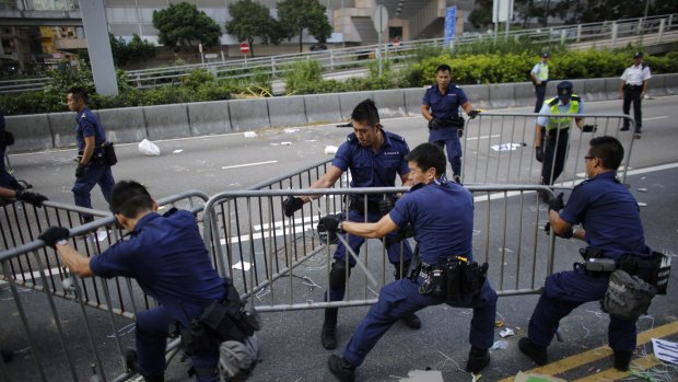 First move: Police remove barricades erected by pro-democracy protesters at the main protest site in Admiralty in Hong Kong.