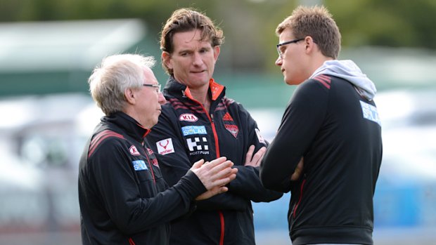 Essendon club doctor Bruce Reid, left, talks to coach James Hird and media manager Justin Rodski during a training session.