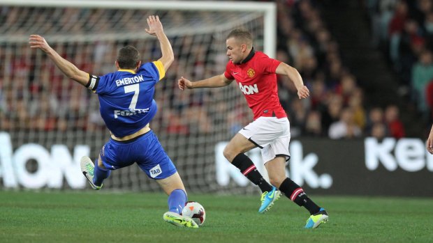 Brett Emerton attempts a lunging tackle against Manchester United at ANZ Stadium in 2013.