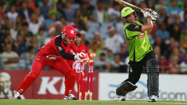 Peter Nevill of the Renegades attempts to stump Chris Tremain of the Thunder.