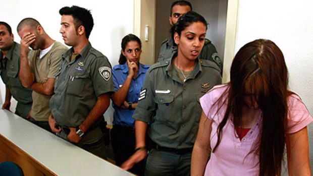 Israeli police separate Marie Pisam (right), who is accused of murdering her four-year-old daughter, and Ronny Ron (second from left) in court.