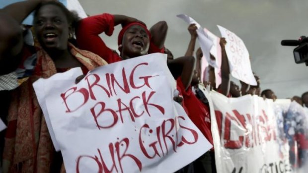 Women react during a protest demanding security forces search harder for 200 schoolgirls abducted by Islamist militants.