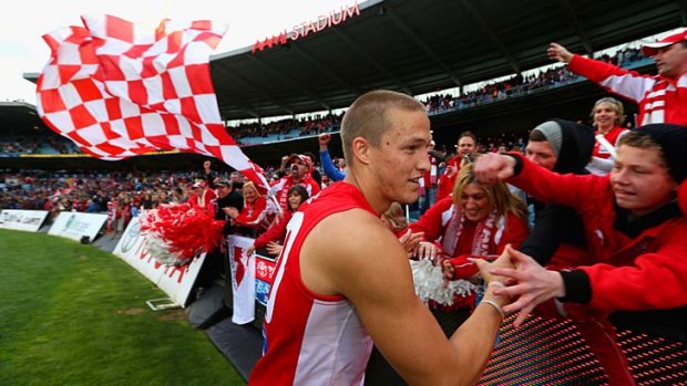 Loyal fans ... Sam Reid of the Sydney Swans greets excited spectators.