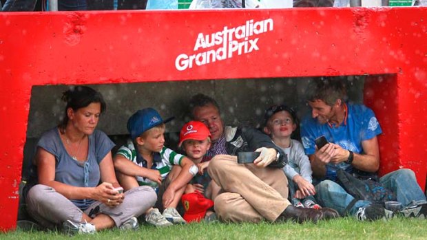 Families take shelter from the rain at Albert Park.