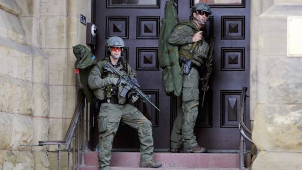 Armed officers on guard on Parliament Hill after the attack.