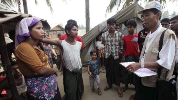 A census taker (right) talks to members of the Rohingya ethnic group in Myanmar's Rakhine state on April 1. The Myanmar government had earlier announced that people would be forbidden from identifying as Rohingya in the census, prompting UN protests.