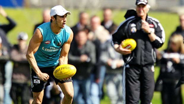 Sharrod Wellingham trains yesterday under the watchful eye of coach Mick Malthouse.