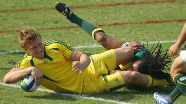 Australia's Lachie Turner dives across the line to score a try.