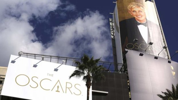 An image of comedian Ellen DeGeneres is seen next to an Oscars billboard raised above the red carpet before the 86th Academy Awards in Hollywood.