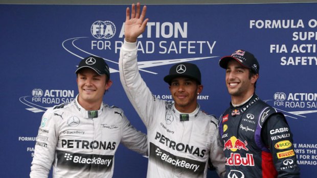 Lewis Hamilton is flanked by Nico Rosberg (left) and Daniel Ricciardo.