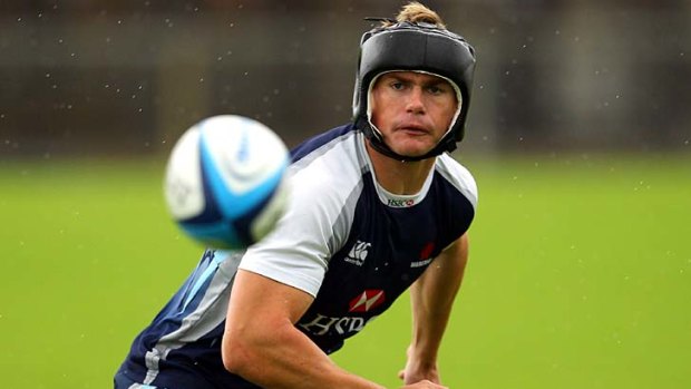 Ready for the fight ... Berrick Barnes takes no chances by wearing boxing headgear at Waratahs training.