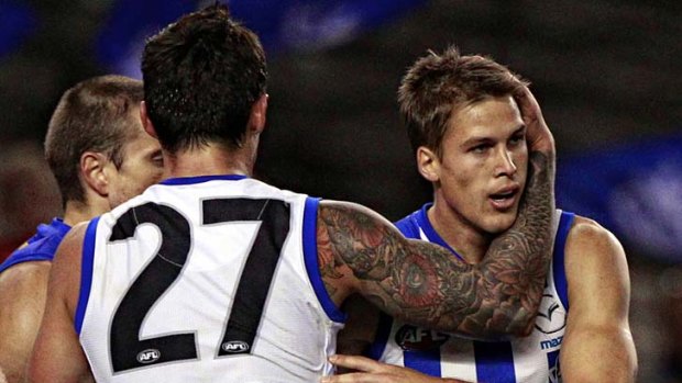 Andrew Swallow is congratulated by teammate Aaron Edwards after kicking a goal at Etihad Stadium yesterday.