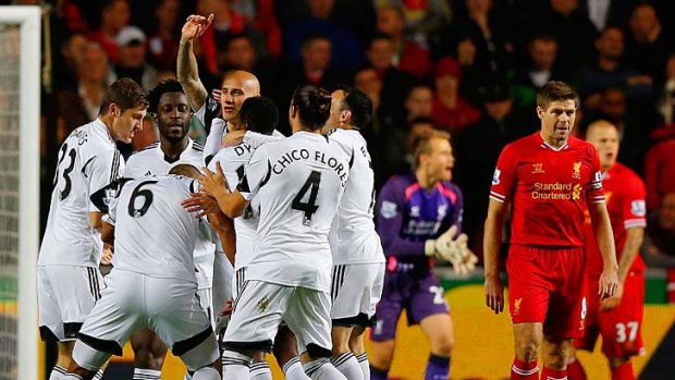 Swansea City's English midfielder Jonjo Shelvey (4L) celebrates after scoring the opening goal.