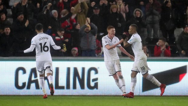 Upset win: Swansea City's Jordan Ayew, right, celebrates scoring his side's second goal of the game.