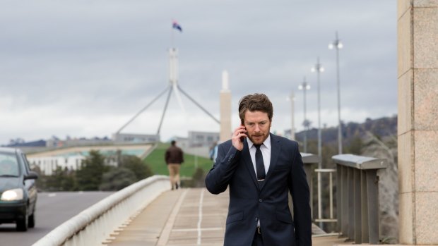 Star of the second series of The Code, Dan Spielman, as Ned Banks walks across Commonwealth Avenue Bridge in Canberra.