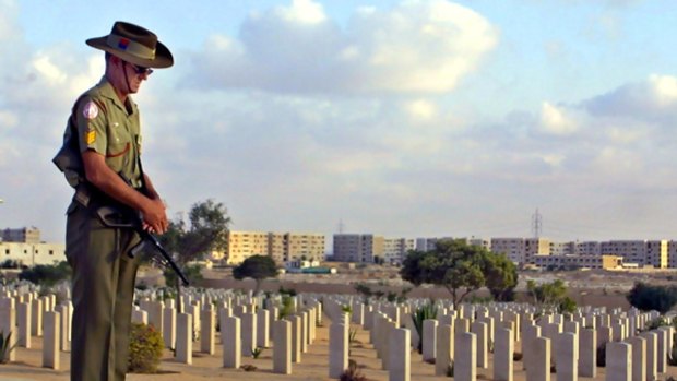 Memories of war ... an Australian soldier honours the El Alamein dead.