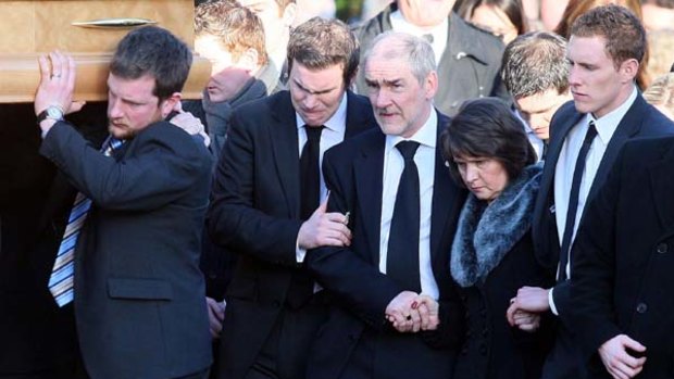 Dark days again ... parents John and Marian Harte and husband John McAreavey (above, right) at the funeral of Michaela McAreavey.