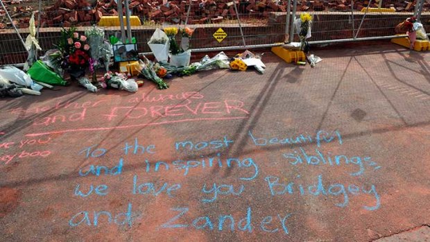 Tributes to Alexander and Bridget Jones beside the accident site. Photo: Mal Fairclough, The Age.