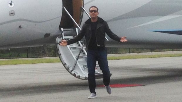 Robbie Williams was in a jovial mood when he stepped off the plane in Perth today.