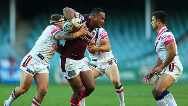 Tony Williams tries to muscle his way past two tacklers during the game against the Sydney Roosters.