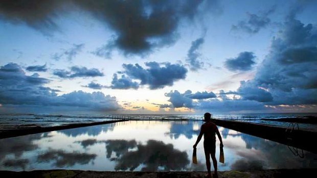 Chris Van Krevel takes an early morning dip in a pool on the Illawarra coast.