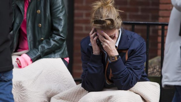 Despair ... a woman is clearly distressed as she makes a phone call after the Boston Marathon bombings.
