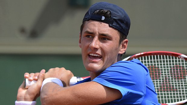 Bernard Tomic has been bundled out of the French Open in straight sets by Colombia's Santiago Giraldo.