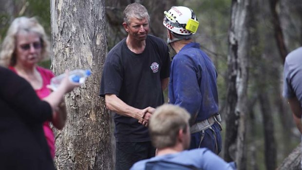 Safe and sound: a caver thanks his rescuer.
