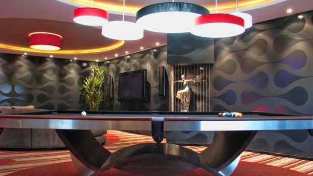 A custom-made pool table, dramatic lighting and groovy wallpaper in the Sunshine Coast man cave designed by Mark Gacesa.