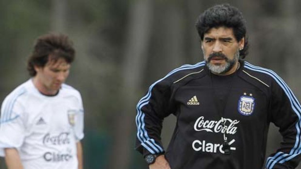 Naked run ... Argentina coach Diego Maradona, right, pictured here in training with Lionel Messi.