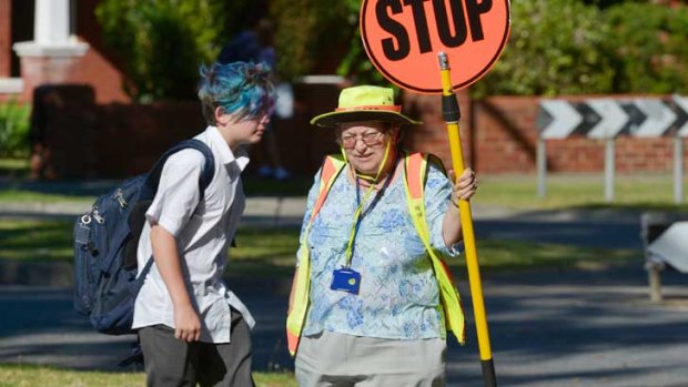 'Lollipop lady' Sue Parsons pictured at work after being injured by a motorist using his mobile phone behind the wheel.
