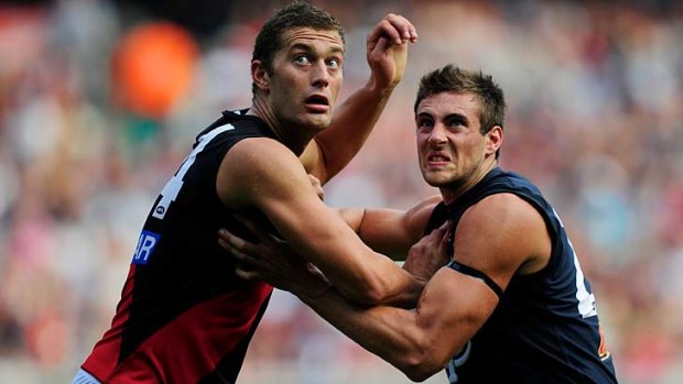 Test of strength: Tom Bellchambers (left) comes to grips with Carlton's Shaun Hampson.