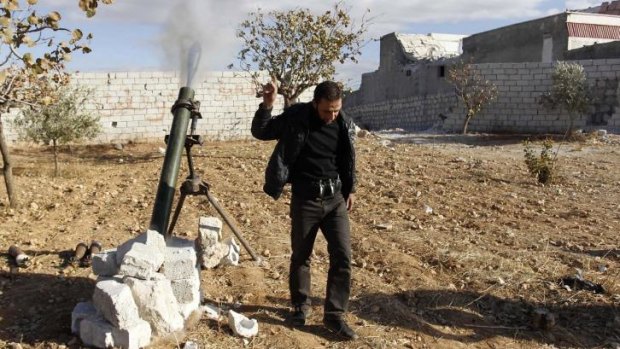 A Free Syrian Army fighter reacts as he fires a mortar shell towards forces loyal to Syria's President Bashar al-Assad in Aleppo.