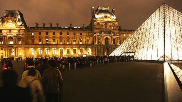 Night tour: A queue outside the Louvre museum in Paris.