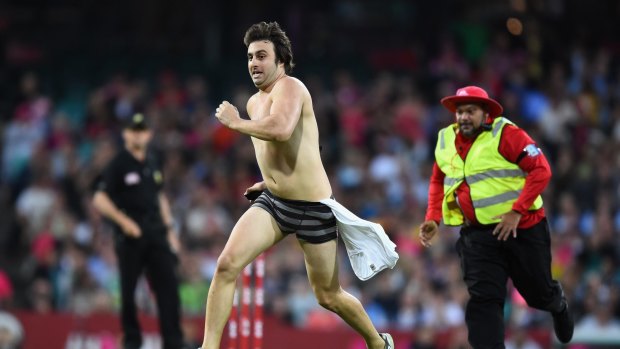 Howzat? A pitch invader enters the field of play during the Big Bash League match between the Sydney Sixers and the Melbourne Stars at Sydney Cricket Ground.