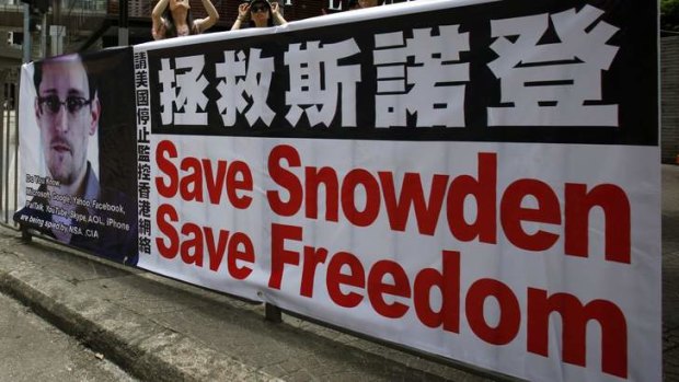 A poster supporting Edward Snowden, a former contractor at the National Security Agency (NSA) who leaked revelations of U.S. electronic surveillance, is displayed at Hong Kong's financial central district June 17, 2013.