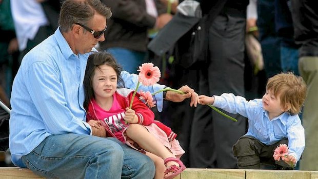Stewart Ashton with his kids Thomas, 2 yrs and Charlie, 4 yrs attending the memorial service on the anniversary of 2002 Bali Bombing at Dolphins Point in Coogee.
