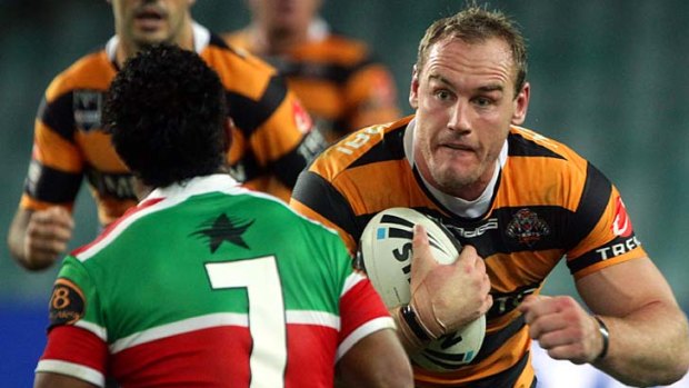 Coming through ... returning Wests Tigers back-rower Gareth Ellis only has eyes for Souths halfback Chris Sandow at  the Sydney Football Stadium last night.